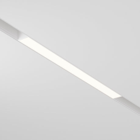 The Basis LED Linear Track Light for Magnetic Exility 12W 3000K - White is a ceiling-mounted fixture featuring sleek design and Warm Glow Lighting, casting an even white glow against a plain white ceiling.