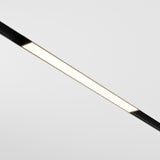 The Basis CCT LED Dimmable Linear Track Light, with a sleek black design, is mounted on a plain white ceiling. Its dimmable 12W LED feature ranges from 2700-6000K, allowing for customizable brightness that illuminates while casting minimal shadows.