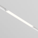 A close-up view of the Basis DALI CCT LED Dimmable Linear Track Light embedded in a white ceiling shows it emitting bright, even light. Its minimalist design integrates seamlessly with magnetic Exility technology, offering optimal lighting control with a modern aesthetic.