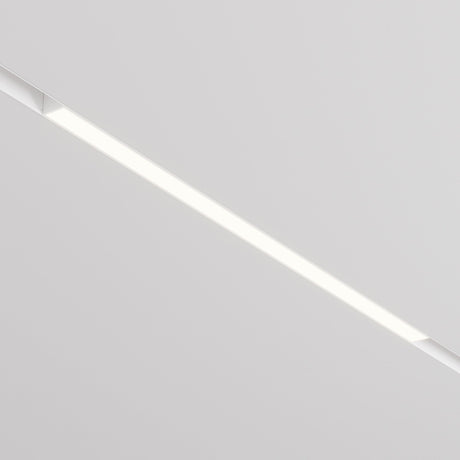 A minimalist ceiling features the Basis CCT LED Dimmable Linear Track Light, set diagonally on a smooth white surface. This fixture offers adjustable color temperature (2700-6000K), emitting a soft, even glow for a modern and sleek ambiance.