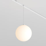 The Luna LED Exility Magnetic Track Pendant Light 5W 3000K - White features a minimalist design with a sleek spherical shade and thin rod, creating an energy-efficient and modern look that complements the clean lines of a bright, neutral room.