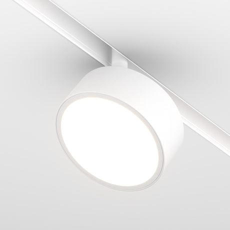 A close-up of the Rado LED Magnetic Exility Track Spotlight (18W, 3000K) showcases its illuminated, even glow. The white frame and sleek track blend effortlessly with the ceiling for energy-efficient lighting.