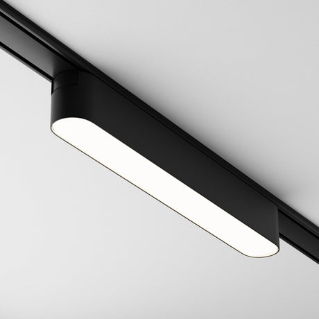 The Basis LED Linear Track Light Radity 12W 4000K - Black is a sleek, black rectangular fixture for magnetic tracks, mounted against a white ceiling, providing bright and even task lighting.