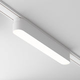 The Basis LED Linear Track Light for Magnetic Tracks Radity 12W 4000K - White features a minimalistic white design with rounded edges, emitting an even glow and sleekly mounted on the ceiling. Its attached to a magnetic track rail for adjustable positioning in minimalist interiors.