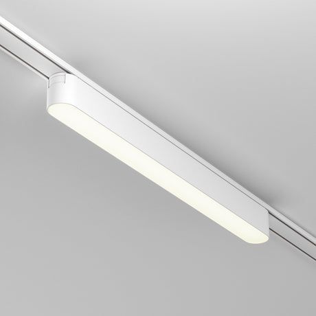 The Basis LED Linear Track Light for Magnetic Tracks Radity 16W 4000K in white is mounted on a gray ceiling, providing a soft glow. Its modern aesthetic and minimalist design, with clean lines, enhance the rooms contemporary appeal.