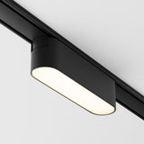 The Basis LED Linear Track Light for Magnetic Tracks Radity 6W 3000K in black offers warm illumination with its sleek rectangular design, enhancing contemporary interiors from its ceiling mount.