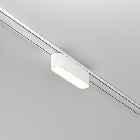 The Basis LED Linear Track Light for Magnetic Tracks Radity 6W 4000K in white emits a soft glow with its modern rectangular design. It complements the light-colored ceiling for a sleek, contemporary look while offering high color rendering for enhanced illumination.