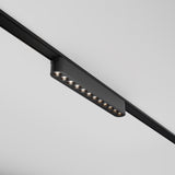 The Points LED Linear Track Light for Magnetic Tracks Radity 12W 3000K in black is a modern, minimalist design with ten small, evenly spaced bulbs that mount on ceiling rails. Its perfect for accent lighting and offers easy adjustment through its magnetic track system.