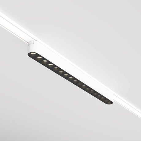 A Points LED Linear Track Light for Magnetic Tracks Radity 16W 3000K in white, featuring multiple circular LED bulbs and a sleek rectangular housing, is mounted on the ceiling to enhance the space with accent lighting. Its minimalistic style perfectly complements the clean, contemporary setting.