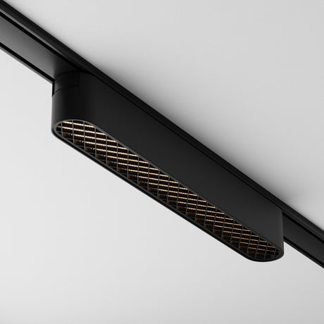 The Basis Grid LED Linear Track Light for Magnetic Tracks Radity 12W 3000K in Black features a sleek grid pattern and metallic finish, providing modern, stylish accent lighting with its minimalist rectangular design when mounted on the ceiling.