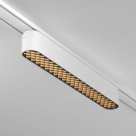 The Basis Grid LED Linear Track Light, seamlessly mounted on the Magnetic Tracks Radity, features a 12W white casing with a grid-like diffuser that emits a warm 3000K glow, elegantly blending into the plain grey ceiling.