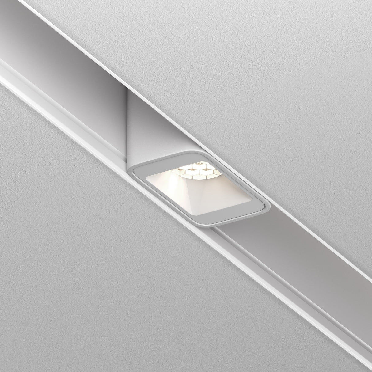 Installed in a white ceiling, the Points S LED Magnetic Exility Track Downlight 2W 4000K emits a soft, bright light with its modern design and rectangular trim, fitting seamlessly into the surface.