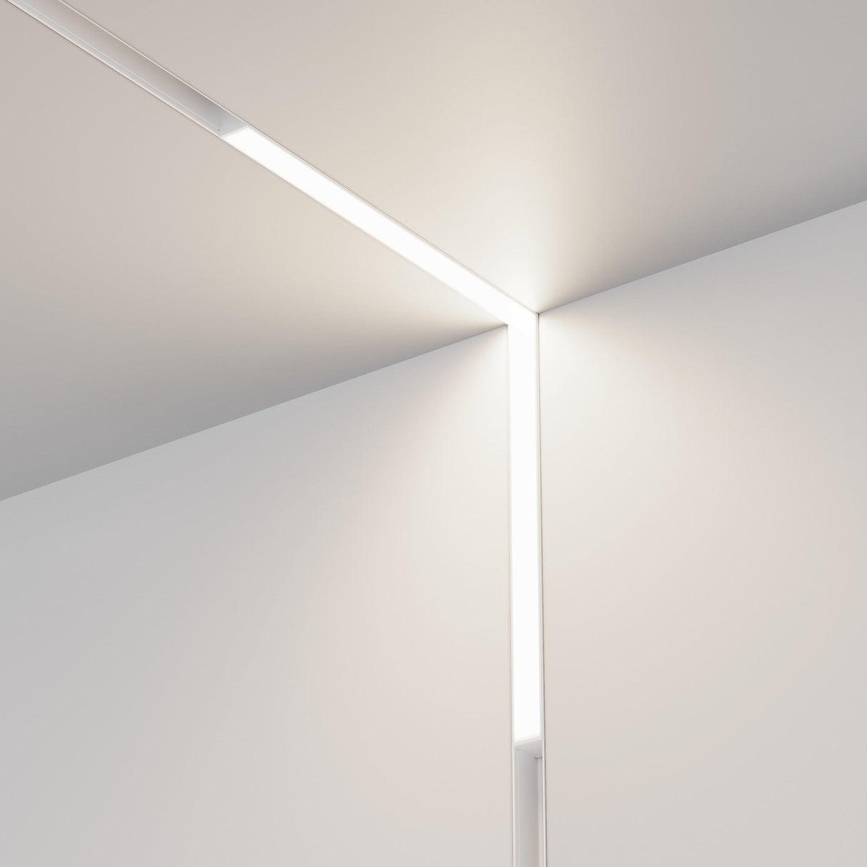 At the minimalist intersection of two walls and a ceiling, the white Basis Angle LED 90° Linear Track Light for Magnetic Exility (24W, 4000K) is embedded along the corner. With smooth, neutral-toned surfaces, this design offers a clean, modern aesthetic with precision lighting.