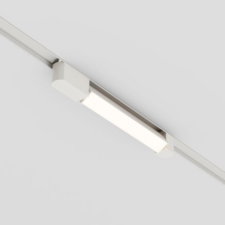 The Basis Rot LED Swivel Linear Track Light, designed for single-phase track unity and equipped with a 12W 3000K output, is mounted on a white ceiling. Its modern, sleek design offers energy-efficient and bright illumination.