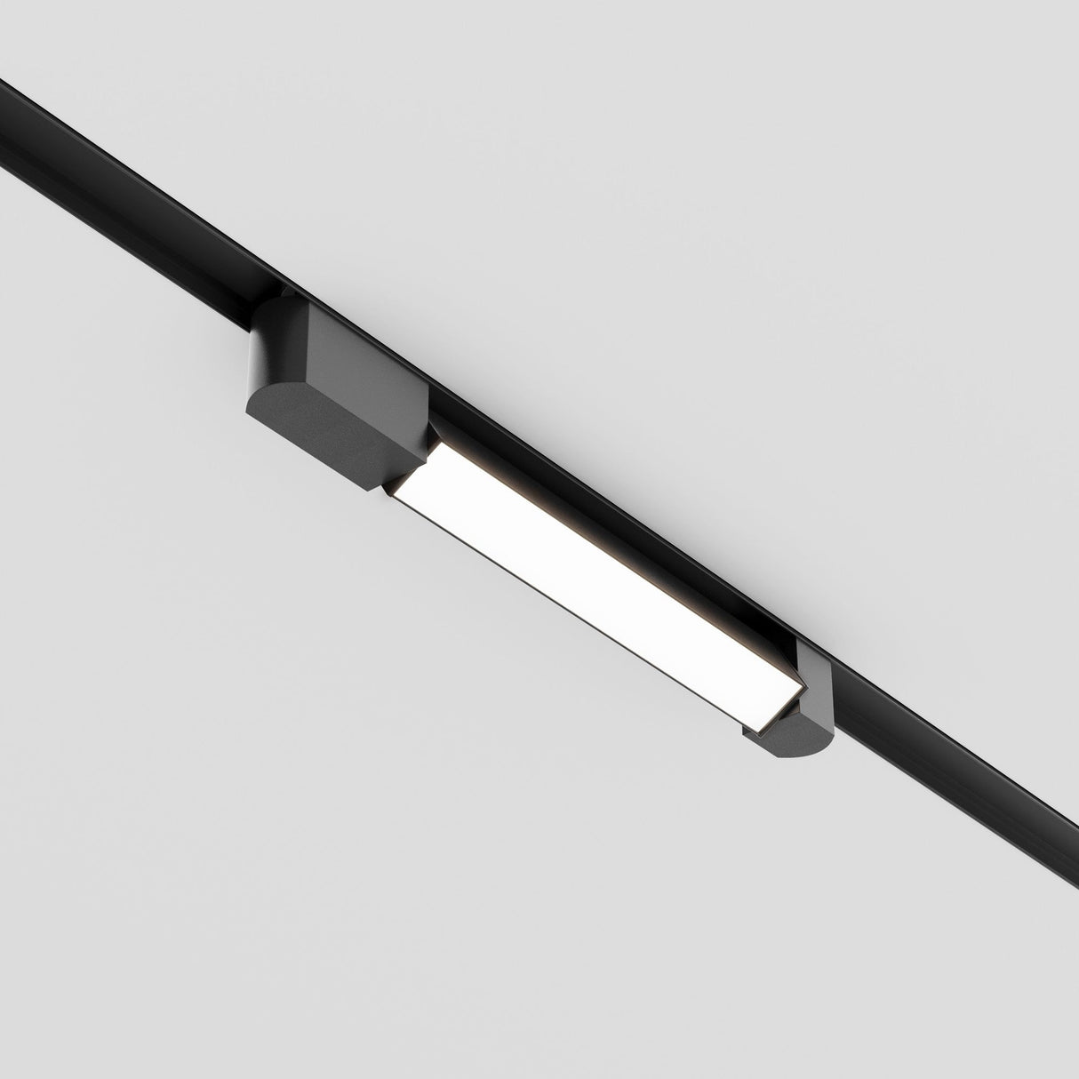 The Basis Rot LED Swivel Linear Track Light for Single Phase Track Unity 12W 4000K - Black is mounted on a white ceiling, providing bright, even illumination for an adjustable and minimalist contemporary look.