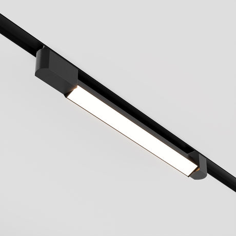 The Basis Rot LED Swivel Linear Track Light for Single Phase Track Unity 24W 3000K in black offers sleek modern illumination with energy-efficient design. Mounted on a white ceiling, it provides adjustable lighting to achieve the perfect ambiance in any room.