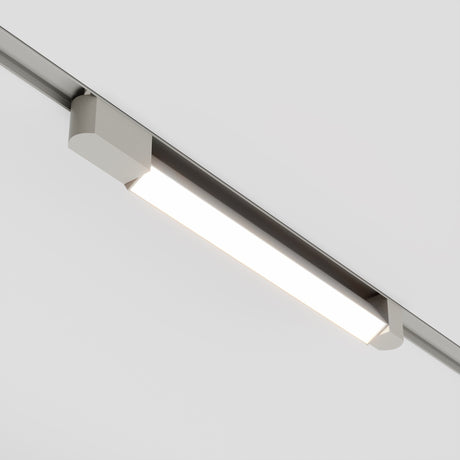 The Basis Rot LED Swivel offers sleek, modern illumination with its rectangular, metallic design and bright LED panel. This energy-efficient 24W, 4000K track light is suspended from an adjustable single-phase track system on a white ceiling, perfect for versatile lighting in any space.