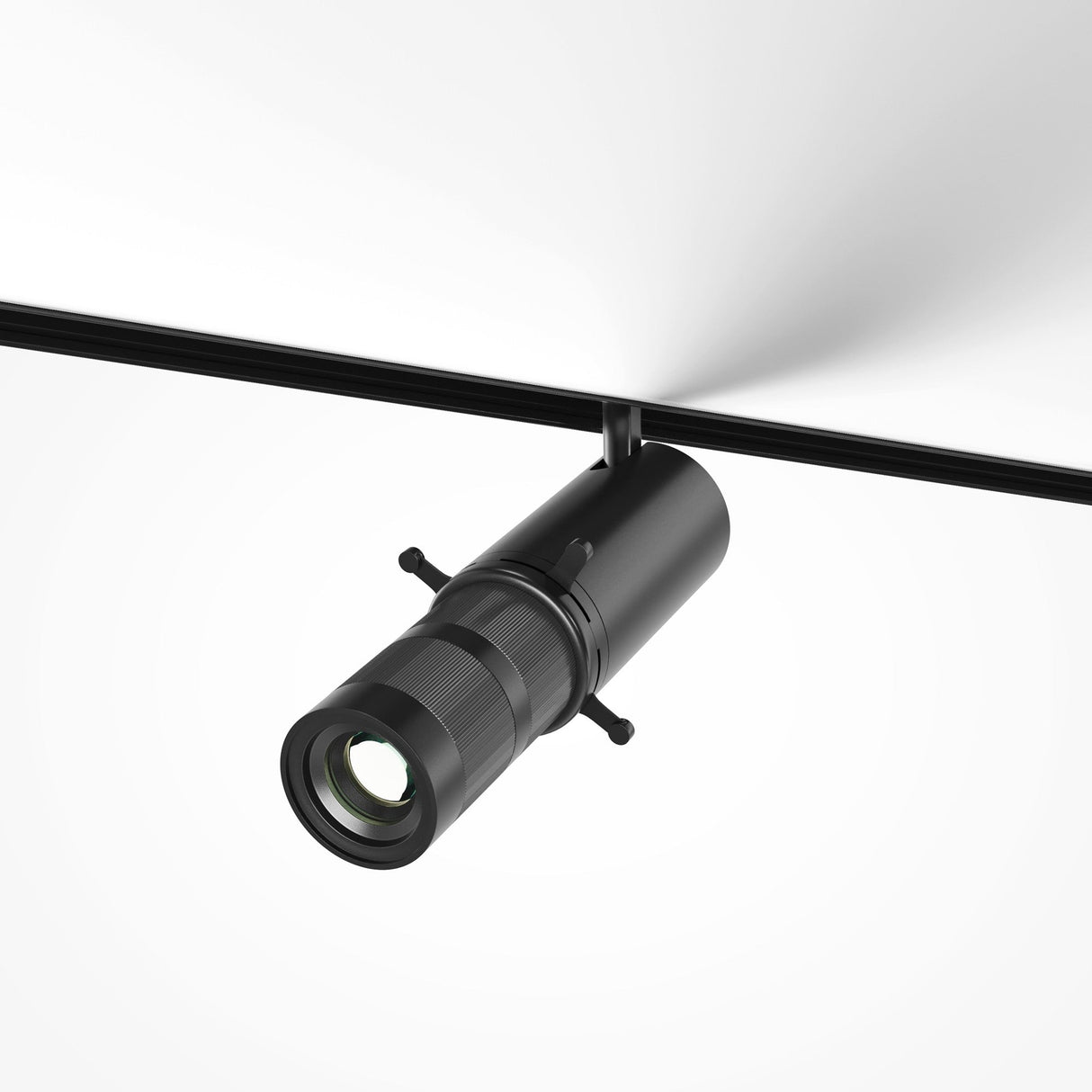 The Gala LED Magnetic Exility Track Spotlight 10W 3000K - Black mounts on a ceiling track, casting warm white light. Its sleek cylindrical design features an adjustable rotating lens for precise light direction.