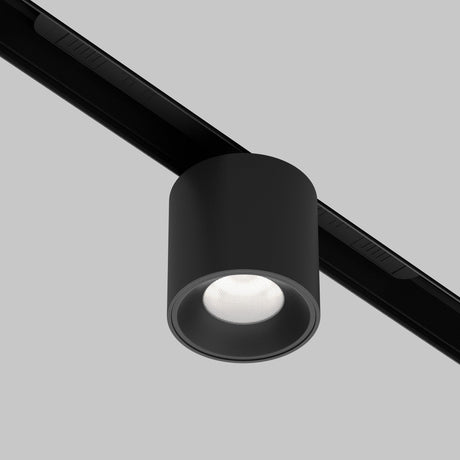 The Alfa S CCT LED Dimmable Magnetic Exility Track Downlight in black offers a sleek cylindrical design with adjustable 2700-6000K color temperature, mounted on a straight track against a plain gray background for versatile lighting solutions.