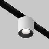 The Alfa S CCT LED Dimmable Magnetic Exility Track Downlight 7W in white, with a textured interior, is mounted on a black track system against a gray background, positioned to shine downward.