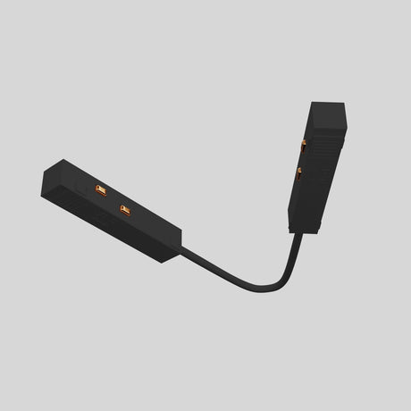 The Exility Track Flexible Corner Power Connector - Black is shown as a black, rectangular hinge-like device with orange connectors and two cable-joined segments, ideal for modern interiors on a plain grey background, seamlessly connecting components.