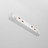 The Exility Track Straight Power Connector in white, featuring a sleek and minimalistic design with three outlets, is mounted on a light grey wall. Its straight power connector complements the subtle markings near the outlets.