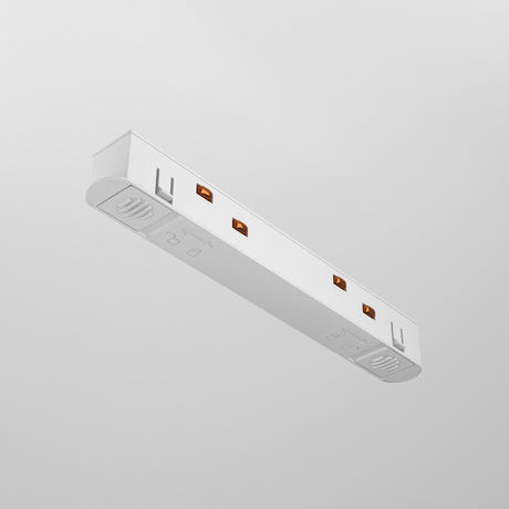 The Exility Track Straight Power Connector in white, featuring a sleek and minimalistic design with three outlets, is mounted on a light grey wall. Its straight power connector complements the subtle markings near the outlets.