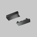 Two black, rectangular Radity Magnetic Surface-Mounted Track End Caps from the 2 Pack (TRA084EC-111B) hover against a light gray background, one showing its smooth top and the other displaying interlocking features, reminiscent of a modern lighting setup.