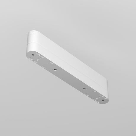 The Radity Magnetic Track Long Adaptor - White is a minimalistic, rectangular ceiling light fixture made from plastic, with rounded edges and multiple mounting holes. Its clean design viewed against a grey background makes it ideal for modern interiors.