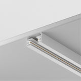 The Unity Single Phase Surface-Mounted Track 2m in white offers a minimalist touch to plain white ceilings, featuring dual parallel lines for light attachment. Its clean and modern design emphasizes sleek aesthetics and simplicity.