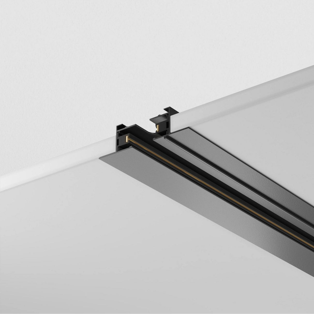 Close-up of the Unity Single Phase Recessed Track 1m in black, showcasing a sleek linear design and recessed mounting. The aluminum body features metallic accents against a white ceiling background.