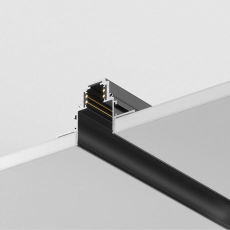 Close-up of the S35 Magnetic Recessed Track 1m for Plasterboard (12.5mm, Black), showcasing its modular ceiling design perfect for customized lighting. The modern structures internal compartments appear sleek and clean against a plain white backdrop.