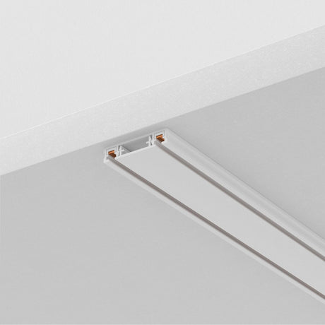 The Radity Magnetic Surface-Mounted Track 1m in white features a sleek design with two exposed copper conductors, providing versatile 48V lighting solutions when installed on flat ceilings.
