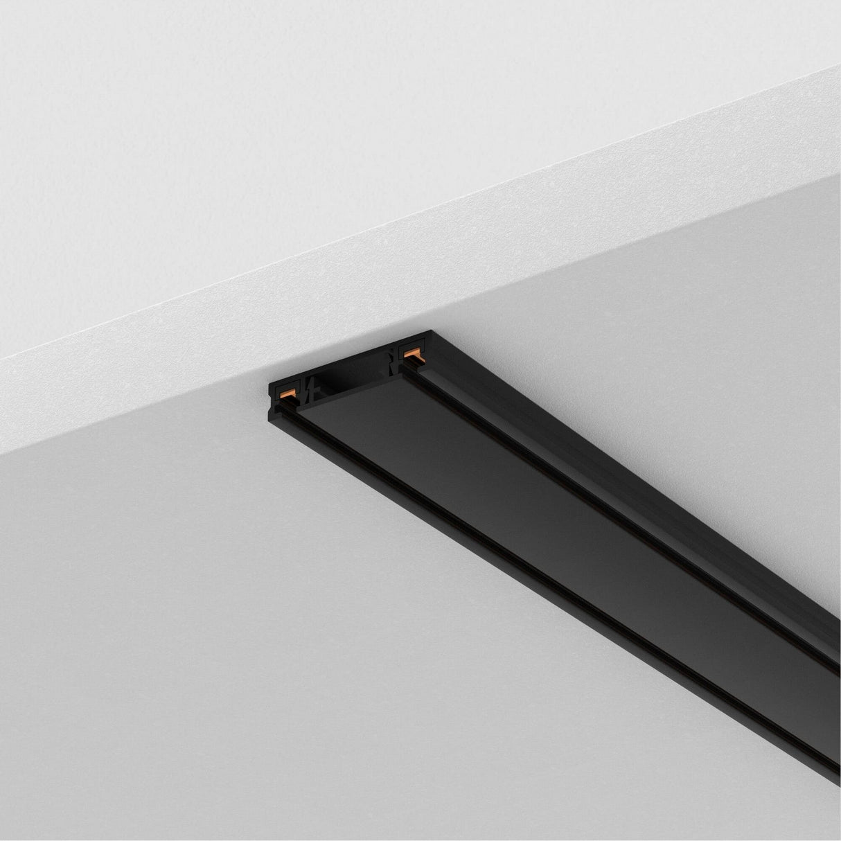 The Radity Magnetic Surface-Mounted Track 2m in black is perfect for modern interiors, mounted on a white ceiling with a sleek design and two exposed copper connections on one end, offering versatile lighting solutions.