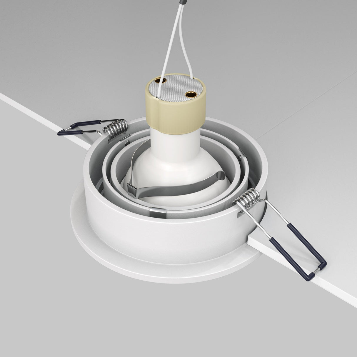 A close-up of the Atom Single Tilt Round Recessed Downlight - White (DL023-2-01W) being installed in a ceiling. It features a minimalist design with a cylindrical base and spring-loaded clips for secure placement, plus two wires on top for electrical connection.