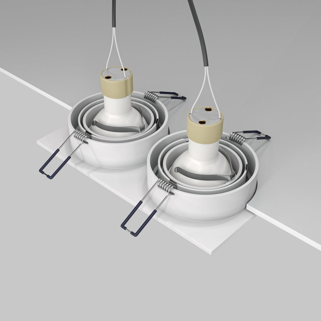 The ceiling view features two Atom Twin Tilt Recessed Downlights in white, with spiral cords and metal springs, against a gray and white backdrop. Their adjustable tilt ensures ideal ambient lighting for any room.