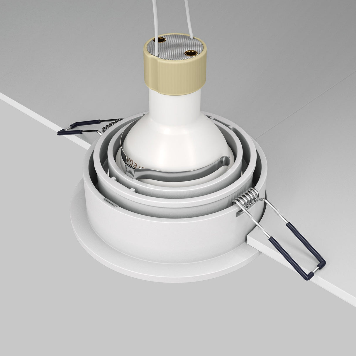 A close-up of the Atom Single Tilt Round Recessed Downlight - White (DL025-2-01W) being installed in a light gray ceiling. The white fixture, with metal clips and wires, features contemporary design elements and an adjustable tilt for precise lighting. All parts are neatly aligned for installation.