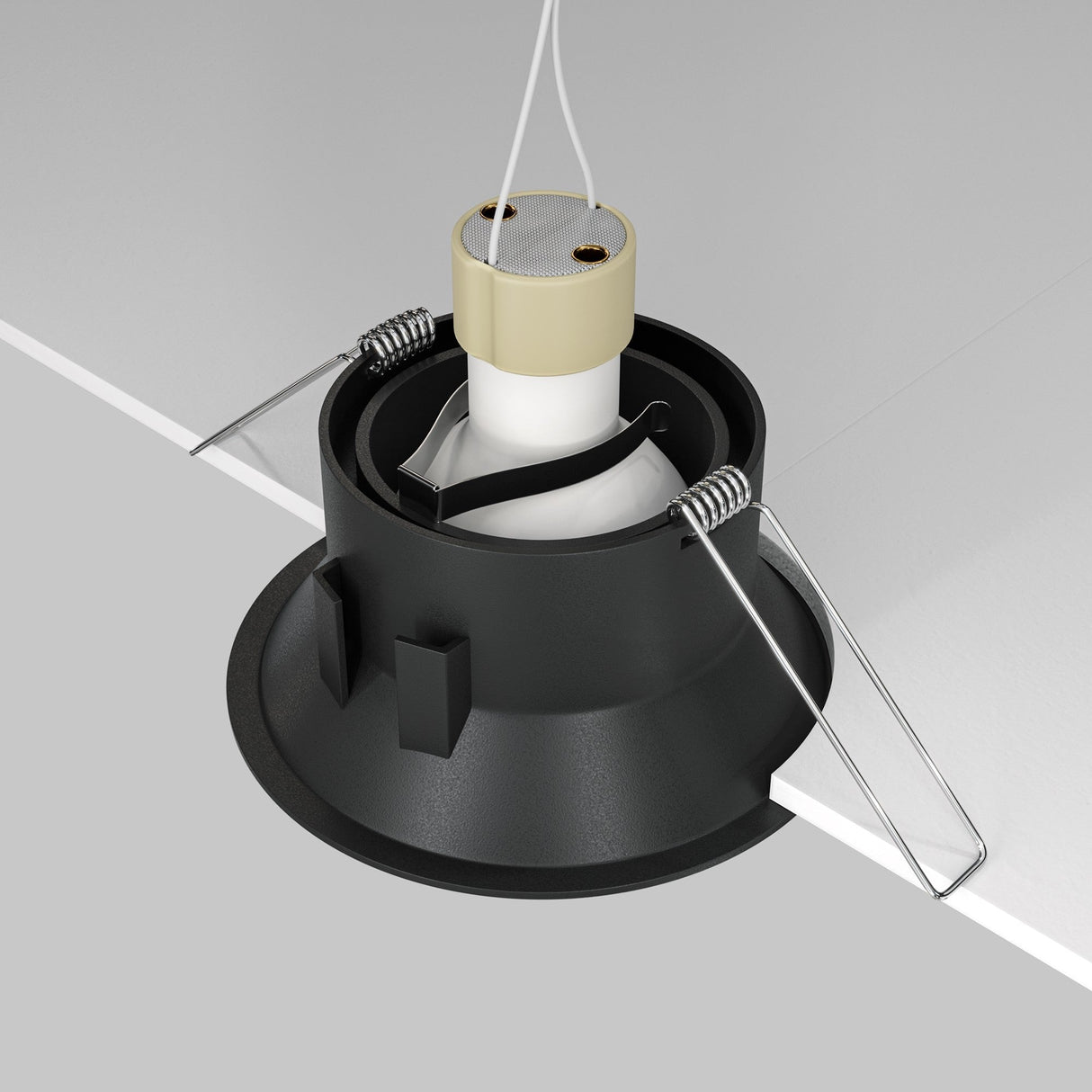 Close-up of the Dot Single Tilt Round Recessed Downlight in black, showcasing its adjustable tilt mechanism and white connector with metal spring clips against a gray background, angled to highlight its installation method.