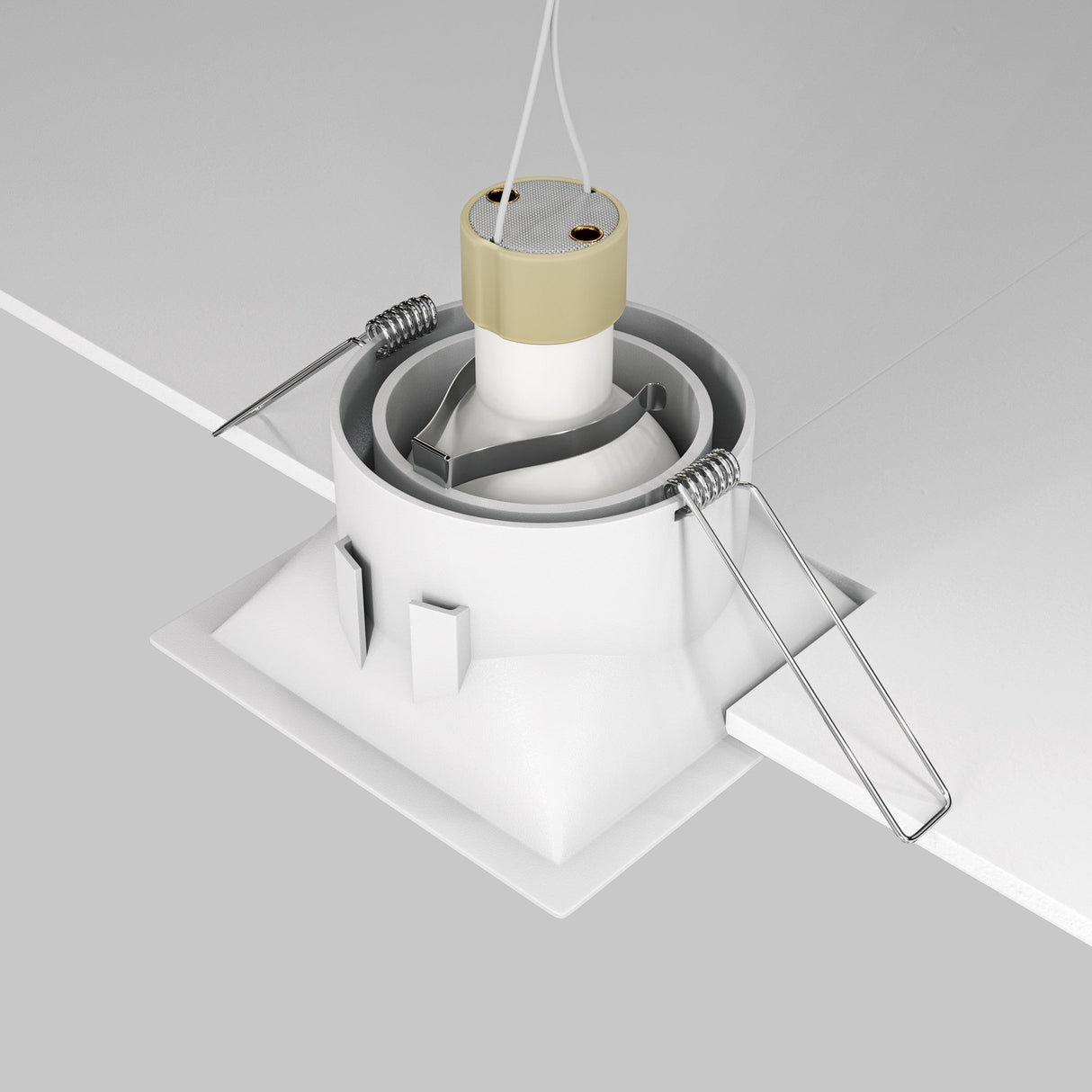 A Dot Single Tilt Square Recessed Downlight - White is being installed, featuring a tilt mechanism, LED lighting, springs, and a square housing. Its mounted into a square ceiling opening with visible wires.