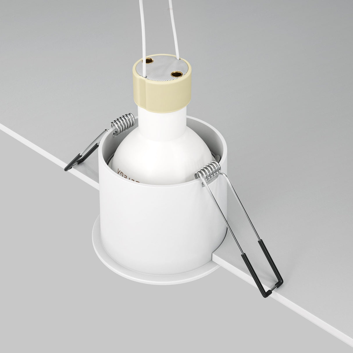 Close-up of the Reif Round Recessed Downlight - White, featuring a cylindrical design ideal for modern spaces. The image displays installation parts such as spring clips and wires, spotlighting the fixture partly embedded in a surface, crafted from premium materials.