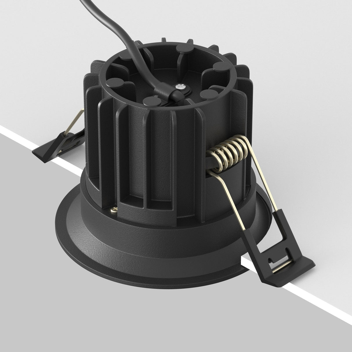 The Round LED Recessed Downlight 12W 3000K - Black boasts a minimalist matte black design and cylindrical ribbed body for heat dissipation. It includes two spring clips for easy mounting, rests against a light gray background, and has an upward-extending discreet black power cable.