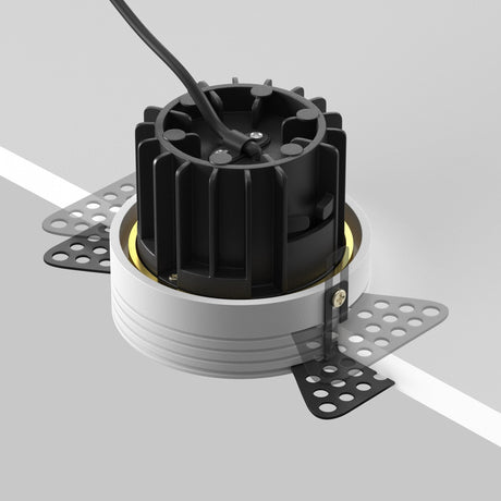 Mounting components for round LED recessed trimless downlight in brass, ensuring a secure and integrated installation.