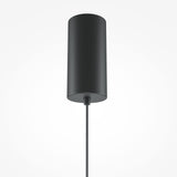 The El LED Round Tablet Pendant Light in Black & Terracotta is a minimalist cylindrical design with a matte black finish, featuring an energy-efficient LED. Hanging from a braided black cord against a white backdrop, it blends industrial and artistic elements seamlessly.