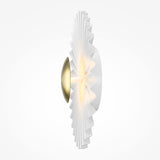 The Fiore Dimmable LED Circle Disc Wall Light in brass features a modern design with a central light source, symmetrical round base, accordion-like pleated white shade, and dimmable function. It emits a radiant effect with a warm, soft glow.