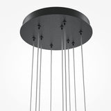 Close-up of the Light Stick LED Dimmable Pendant in black, showcasing minimalist elegance with sleek cables hanging from a circular base against a white background.