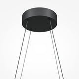 The Halo Dimmable LED Suspension Light 3000-4000K in black features a sleek circular fixture with four cables, offering energy-efficient and customizable ambiance against a plain background.
