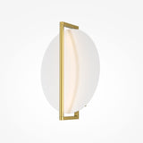 The Mira LED Wall Light features a circular design with a thin brass frame and gold finish. Its opaque white diffuser creates a soft glow, offering an energy-efficient, minimalist, and contemporary style that seamlessly mounts against a white background.