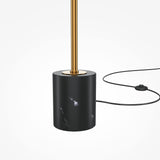 The Breeze LED Floor Lamp - Brass features a modern design with a black marble base, brass-finished gold rod, and energy-efficient lighting. A black power cord with a switch accompanies it on a pristine white background.