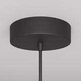 The Arrow 1 Light Long Cone Pendant in black, featuring a minimalist design with adjustable height, is elegantly mounted on a gray ceiling.