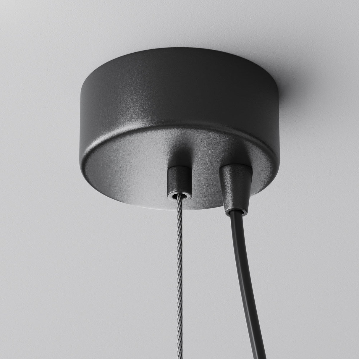 The Efir LED Pendant Light 25W - Matte Gold has a black ceiling fixture with a braided metallic cord and smooth black cable, offering energy-efficient brilliance against a white ceiling, seamlessly blending style with functionality.